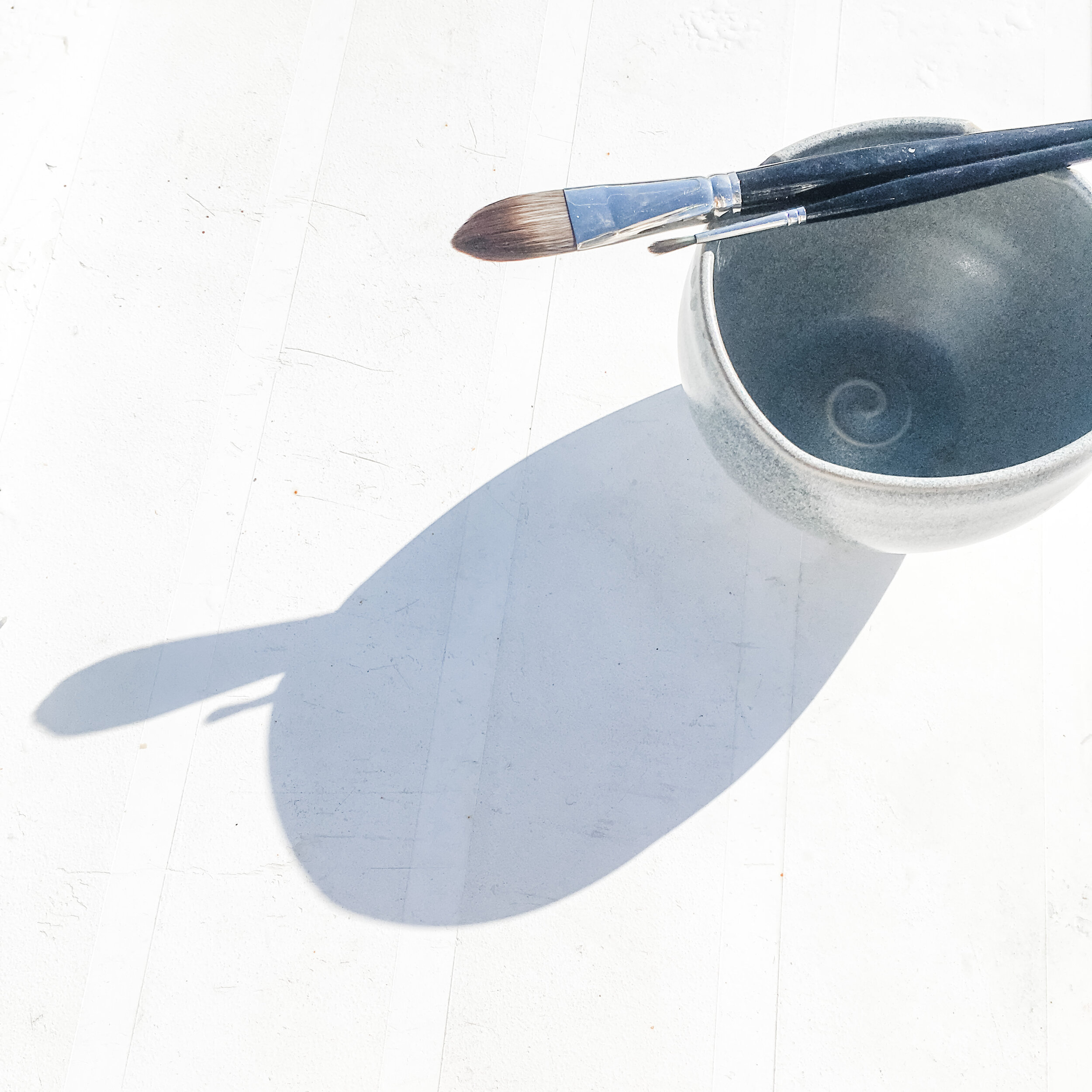 Watercolour brushes and water pot